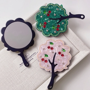 Elegant tree-shaped acetate hand mirror with colorful rhinestones and cherry accents