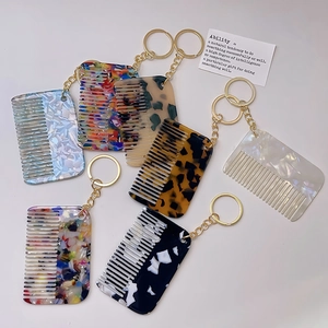 Acetate hair comb keychains in seven marble patterns with golden metal rings