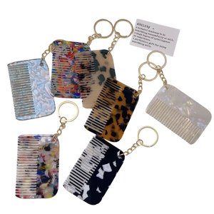 Set of minimalist acetate comb keychains with marble patterns and golden rings