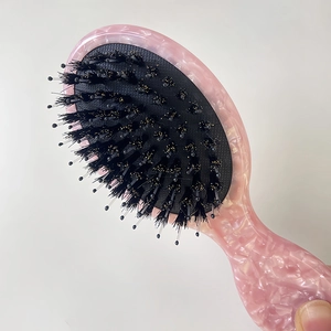 Pink marble texture mini hairbrush with boar bristles and nylon pins on air cushion