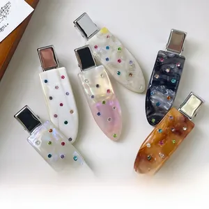Close-up of 6-piece acetate hair clips with colorful rhinestones in multiple patterns