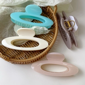 Elegant hollow oval hair claw clips in four Morandi colors with glossy finish