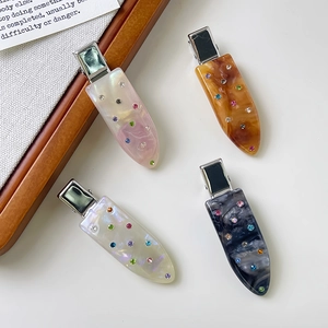 Elegant acetate hair clips set with colorful rhinestones in assorted marble patterns