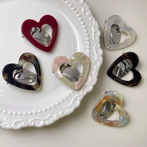 French retro hollow heart acetate hair clips set in various colors on elegant plate