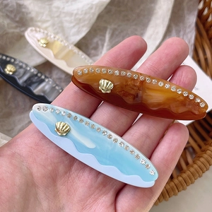 Set di 4 fermagli per capelli in acetato marmorizzato con strass e dettagli dorati