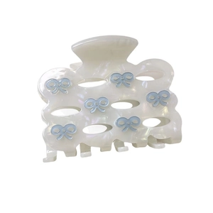 Elegant cream acetate bow hair claw clip with light blue ribbon details and wavy edges