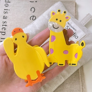 Cute acetate hair claws in yellow duck and giraffe animal designs for women's hairstyling