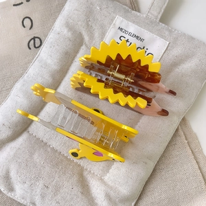 Close-up of yellow hedgehog and puppy acetate hair claws with metal spring mechanism