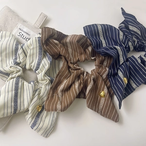 Striped fabric scrunchies set with gold heart charms in beige, brown and navy blue