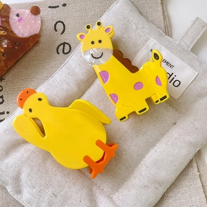 Cute animal acetate hair claws set featuring yellow duck and giraffe shaped hair clips