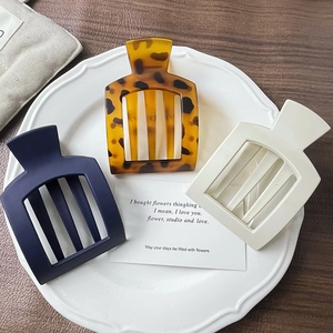Flat square hair clips set in tortoise shell, matte navy, and cream white colors