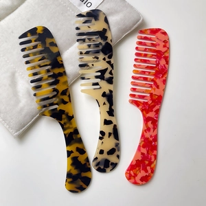 Acetate wide tooth combs in tortoiseshell, marble and cow print patterns with handle