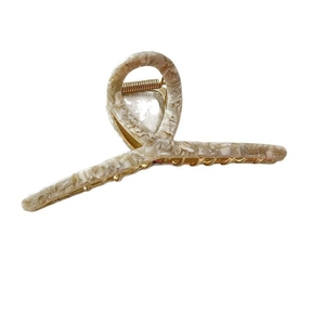 Elegant large acetate hair claw with cream marble pattern and golden metal spring