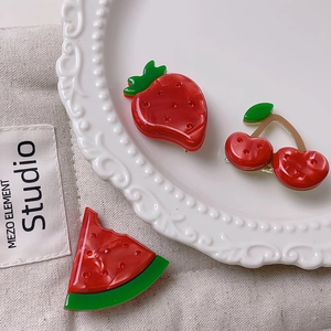 Cute fruit-shaped hair clips with strawberry and cherry designs featuring red rhinestones