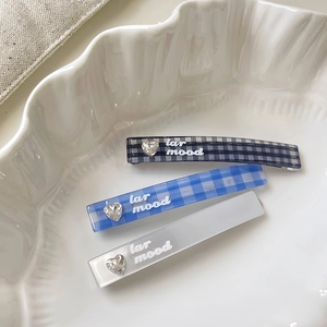 Three-piece checkered hair clip set with heart rhinestones and soft cream style aesthetics