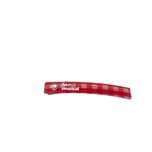 Red plaid hair clip with crystal heart detail and white art text on white background