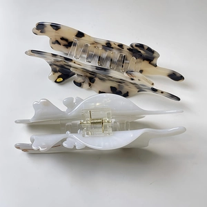 Detail of cat silhouette hair claw clips in tortoise shell and white acetate