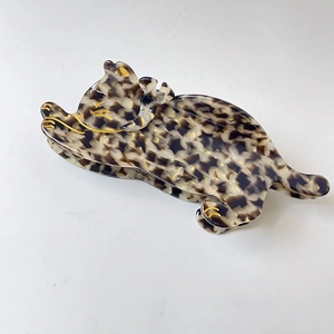Leaping cat hair claw clip in tortoiseshell pattern with gold outline details