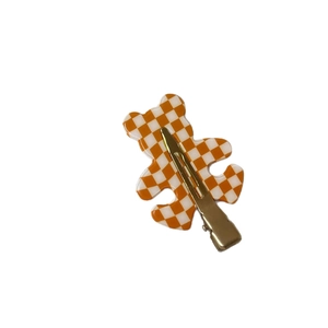 Cute acetate bear hair clip with orange and white checkerboard pattern and gold metal clip