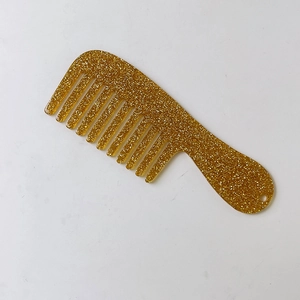 Close-up of golden glitter mini hair comb keychain with thick acrylic material