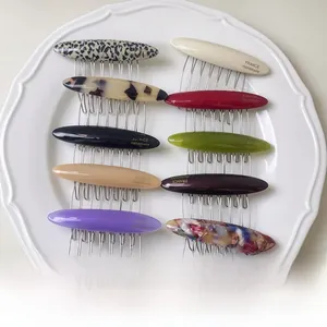 Detailed set of 10 tortoiseshell acetate hair side combs with gold logo and metal teeth