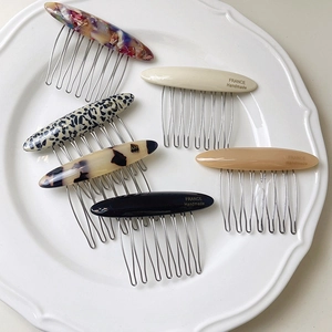 Set of six oval acetate hair combs with seven metal teeth in assorted marble and leopard prints