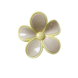 Cute two-tone flower claw clip in beige and yellow with a glossy resin finish for hair styling