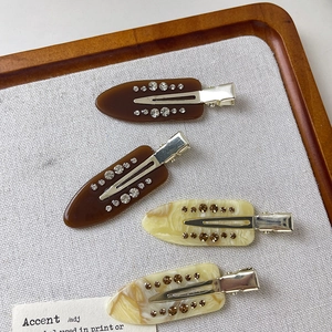 Set of four acetate hair clips with rhinestones in brown and marble pattern