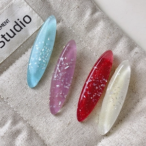 Set of 4 ocean-themed oval hair clips in blue, purple, red, and white resin with glitter
