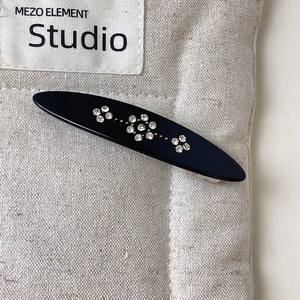 Detail shot of vintage black hair clip with sparkling rhinestone floral patterns