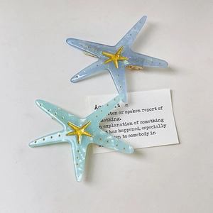 Chic Y2K starfish hair clips in blue and green acetate with golden metal accents