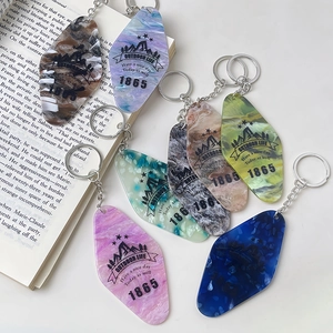 Colorful acrylic diamond keychains with marble patterns and outdoor slogans