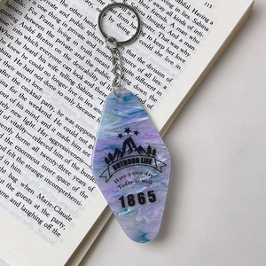 Macro detail of diamond acrylic keychain with blue marble pattern on an open book
