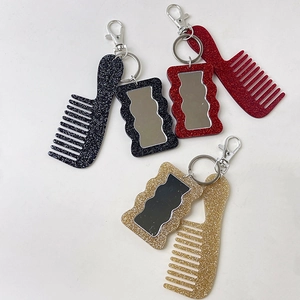 Glittery mini comb and wave mirror keychain charms in black, red, and gold glitter finish