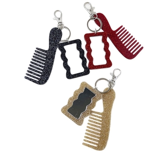 Glittery mini comb keychain set in black, red, and gold colors with silver lobster clasps