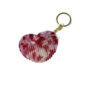 Pink heart-shaped acetate comb keychain with marble texture and gold ring