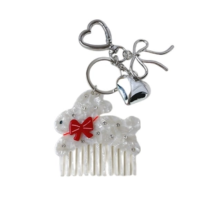 Porte-clés peigne chat en acétate avec texture marbrée et nœud rouge élégant