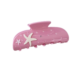 Pink ocean style hair claw clip with white starfish and rhinestones on white background
