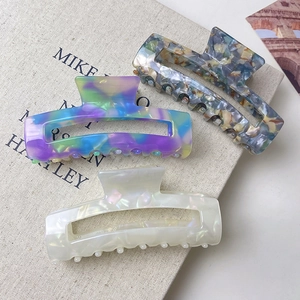 Minimalist large acetate hair claw clips in multi-color and pearlescent finishes for women
