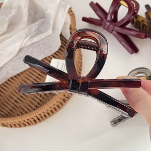 Elegant large bow hair claw clip in tortoise shell and burgundy colors for thick hair