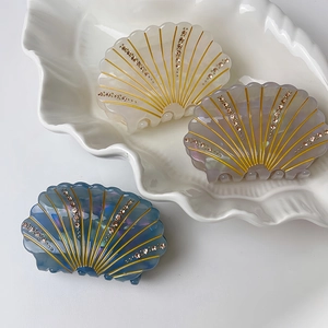 Shell shaped hair claw clips with iridescent finish and inlaid rhinestones for women