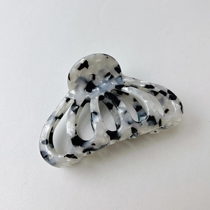 Close-up of marble texture acetate hair claw clip with strong metal spring