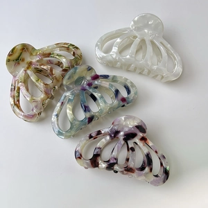Set of four elegant marble and pearl acetate shell hair claws with a vintage hollow design