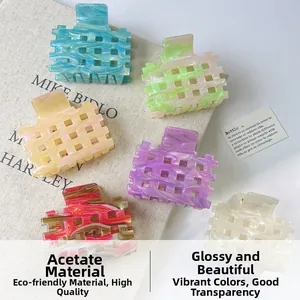 Detailed macro view of colorful hollow acetate hair claws in various vibrant marble patterns