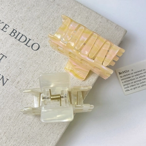 Pearlescent colorful hollow hair claws in yellow pink and cream white acetate