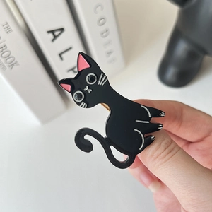 Dettaglio molletta per capelli a forma di gatto nero in acetato con fermaglio dorato