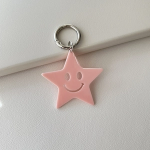 Pink acrylic star keychain with hollow smiley face and silver metal spring ring