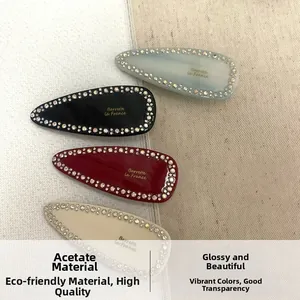 Set of four water-drop acetate hair clips with rhinestones and Barrette la France text