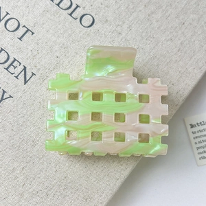 Close-up of green marble pattern acetate hair claw clip with rectangle hollow design