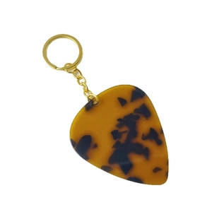 Water drop guitar pick keychain with amber tortoise shell texture and gold keyring